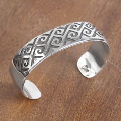 Designed by Maria Belen Nilson this cuff bracelet from Mexico will add the beauty of Taxco handicrafts to your wardrobe. The bracelet is handcrafted of high-polish sterling silver accentuated by curling patterns at the front. The patterns are detailed with a darkly oxidized finish.