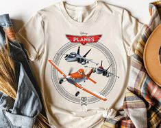 Get your order now: Peckshirt  Disney Planes Dusty Crophopper With Bravo And Echo T-shirt, Magic Kingdom Unisex T-shirt Family Birthday Gift Adult Kid Toddler Tee - Print In Your Way Disney T-shirt With Sublimation Print For Fan Events, Disney Fan Event Crew Neck T-shirt With Character Print, Sublimation Print Crew Neck T-shirt For Disney Fan Events, Crew Neck T-shirt With Sublimation Print For Disney Fans, Fun Crew Neck T-shirt For Disney Trips, Disney Crew Neck T-shirt With Sublimation Print, Dusty Crophopper, Planes Birthday, Disney Planes