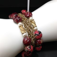 *Description: This is a beautiful Kramer red bracelet and clip earrings from the late 1940s to early 1950s. I tested the gold on the bracelet and it tested at 22K gold surface metal. The red beads are molded so they would be made of thermoset and they have gold glitter inside in places. There are two twisted gold beads with faux pearls on each side, three rows of gold chain on the bracelet with two rows of red art beads. The earrings have matching red solid beads with the same tones and are sign Gold Beads Jewelry For Evening, Vintage Yellow Gold Jewelry For Festive Occasions, Vintage Gold Beaded Jewelry, Vintage Gold Beads Jewelry For Formal Events, Vintage Formal Jewelry With Gold Beads, Formal Vintage Beaded Bracelets With Round Beads, Vintage Gold Beaded Bracelets, Vintage Gold Beads Jewelry For Party, Vintage Gold Beaded Jewelry For Parties