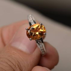 This is a gorgeous handmade creation. Its beauty is its simplicity & Elegance. The 7*9 mm oval shape faceted natural citrine is crafted in solid sterling silver and with rhodium plated. All item is sent in a beautiful gift box If you have any idea of design your ring,pls contact me directly. You can realize more lovely stuff clicking the link https://www.etsy.com/shop/knightjewelry?refshopsection_shophome_leftnav Please leave the correct address and you phone number for delivering successful Yellow Gemstone Ring, Cushion Cut Wedding Rings, November Birthstone Ring, Brown Gemstone, Smoky Quartz Ring, Yellow Gemstones, London Blue Topaz Ring, Citrine Stone, Citrine Ring