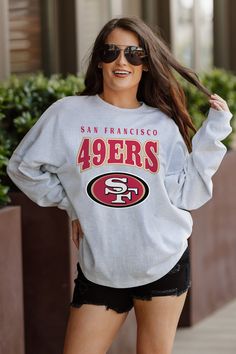 Designed for the ultimate fan, our San Francisco 49Ers drop shoulder long sleeve tee combines a relaxed fit, heathered finish and luxurious French Terry knit. With a ribbed neckline and cuffs, you'll stay stylish and comfortable while showing your unwavering team support. Game Day Long Sleeve Tops With Team Logo, Sports Fan Long Sleeve Top With Team Logo, Sports Fan Long Sleeve Tops For Streetwear, Long Sleeve Top With Team Name For Fall, Long Sleeve Tops For Sports Fans Streetwear, Fan Apparel Long Sleeve Tops With Team Logo, Collegiate Long Sleeve Graphic Print Tops, Long Sleeve Team-colored Tops For Fans, Long Sleeve Tops With Team Logo For Fans