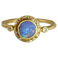 Bluish Purple, 0.60ct Round Australian Boulder Opal, Stackable Ring with Diamond Detail, 24K Solid, Yellow Gold. One of a Kind Ring. This piece would make a great stacker ring.   Details: Diamonds: 0.05ct (12 Diamonds) Opal: 0.60ct. Size: 6 1/2 (US) About Opal: In ancient times, this stone was believed to possess all the characteristics of all gemstones and is used because it represents hope, clarity, and truth. Queen Victoria is thought to have gifted her five daughters' opal jewelry at their w Boulder Opal Ring, Unique Mens Rings, Bluish Purple, Stackable Diamond Rings, Big Jewelry, Platinum Diamond Rings, Australian Boulder Opal, Opal Earrings Stud, Ring With Diamond