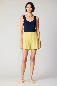 Embrace warmer days with these tailored shorts in a citrusy pastel hue. Designed to sit high on the waist, the pair has a tidy silhouette accented by crisp pleating and welt pockets at the back. Perfect for brightening your look, it's a natural companion to our coordinating blazer. •Zip fly •Hook & eye closure •Pleated waist •Slant pockets at front •Welt pockets at back Item number 2370248 SELF: 72% POLYESTER 23% RAYON 5% SPANDEX LINING: 95% POLYESTER 5% SPANDEX Yellow Summer Shorts For Work, Chic Yellow Shorts For Workwear, Yellow Short Bottoms For Work, Yellow Short Length Bottoms For Workwear, Yellow Workwear Bottoms Shorts, Yellow Short Length Workwear Bottoms, Yellow Shorts For Workwear In Spring, Yellow Shorts For Spring Workwear, Yellow Workwear Shorts For Spring