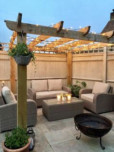 an outdoor living area with couches, chairs and lights on the roof above it