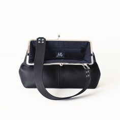 "This vintage style kiss lock frame handbag with a modern twist is handcrafted with butter soft, semi-structured leather (not rigid) and is available in SIX colors (black, navy, dark brown, red, burgundy or taupe) and TWO hardware finishes (silver or antique brass). You also have several shoulder strap choices - a .75 inch wide standard strap, a 1.5 inch wide strap, a .75 inch wide crossbody strap, a .75 inch wide \"shorty\" strap, or a .75 inch wide \"shorty\" strap with a .75 inch wide crossbo Leather Colors, Frame Bag, Handbag Charms, Hardware Finishes, Red Burgundy, Mid Size, Wide Straps, Crossbody Strap, Color Choices