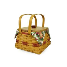 a woven basket with handle and handles is shown on a white background, it has a flowered fabric lining