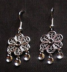 Beautiful hand crafted Traditional Antique Silver filigree Flower Norwegian Solje Style earrings made of silver plated wire, silver plated drops and lovely silver plated earwires. Earrings measure 1.5 inches long and .75 inches wide on either .925 Sterling Silver earwires or Silver Plated Earwires. Add the lovely matching necklace by clicking on this link: https://www.etsy.com/listing/567478361/pamela-antique-silver-flower-and?ref=listing_published_alert All soljes use a variety of dangles to wa Silver Flower-shaped Metal Earrings, Bohemian Silver Flower Earrings, Bohemian Silver Flower-shaped Earrings, Bohemian Silver Flower Shaped Earrings, Silver Bohemian Flower Earrings, Silver Bohemian Flower-shaped Earrings, Silver Teardrop Flower Earrings, Silver Teardrop Flower Earrings For Pierced Ears, Nickel Free Silver Metal Flower Earrings