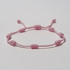 "The 7 Knot bracelet is made with a nylon braided cord of 1mm in diameter. - - - - - - - - Bracelet length - Adjustable size open from 15cm (5.9\") to 25cm (9.8\"). - - - - - - - - Meaning of the 7 Knots Bracelet - The seven knots on the bracelet represent seven wishes or desires that the wearer wishes to be granted. These desires can vary from person to person, including good health, wealth, success, love, happiness, and protection. Each knot is believed to hold a unique energy, and tying the knots is thought to imbue the bracelet with the wearer's intention and energy. ◽ More colors and models are available in the shop. ◽ Just check out the shop. ✍ If you have any questions please contact me." Handmade Pink Nylon Cord Friendship Bracelets, Handmade Adjustable Nylon Thread Bracelets, Handmade Adjustable Nylon Thread Bracelet, Handmade Pink Braided Nylon Cord Bracelet, Adjustable Pink Nylon Cord Bracelet, Adjustable Sliding Knot Nylon Thread Bracelets, Casual Nylon Thread Bracelets As Gift, Casual Pink Braided Bracelet, Adjustable Pink Braided Friendship Bracelets