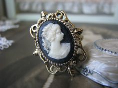 A wonderful vintage Victorian Gothic style black and cream/white cameo ring.  This ring was produced in the 1950's. The cameo is made of lucite and measures 18mm x 15mm.  The top of the ring measures about 1 1/8'' x 1''.  The ring is adjustable. In excellent, like new/never worn condition. Victorian Rings Vintage, Victorian Style Rings, Victorian Gothic Style, Black Cameo, Gothic Ring, Costume Rings, Image Swag, Gothic Rings, Cameo Ring