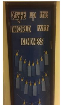 a bulletin board with clothes pins attached to it and the words, light up the world with kindness