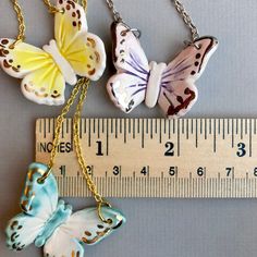 "This listing is for one hand made ceramic butterfly pendant necklace. A perfect gift to bring some sunshine , butterflies carry a message and symbolism of rebirth, transformation, joy, and tapping into the miracle of life in the present moment. Each pendant is hand-sculpted and glazed so no two will ever be exactly alike! Just about an 1.5\" with shiny glasslike glaze and enhanced by real 22k gold or white gold accents. Butterflies are set on an 18\" chain, in gold-plated or silver or finish.* Top Ear Piercing, Ceramic Butterfly, Necklace Ceramic, Handmade Pendant Necklace, Ceramic Earring, Butterfly Pendant Necklace, Tiny Earrings, Cat Earrings, Butterfly Necklace