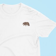 Brown Bear Tshirt Soft 100% Organic Cotton. Unisex Fit. T-SHIRT INFO The t-shirt is Stanley/Stella Organic 100% Cotton. We use sustainable fabric and fair trade certified. Sweatshop free and WRAP certified. T-shirt is embroidered to order. We donate money to animal charities. SIZING 🌼🌼 UK Sizes 🌼 X-Small approx Size 6-8 Small approx Size 8-10 Medium  approx Size 12-14 Large  approx Size 16 X Large  approx Size 18 2XL approx Size 18-20 3XL approx 20-22 4XL approx 24 5XL approx 26 White Embroidered Relaxed Fit T-shirt, Organic Cotton Short Sleeve T-shirt With Front Print, White Organic Cotton Short Sleeve Shirt, Graphic Tee With Embroidered Text For Everyday, Everyday Graphic Tee With Embroidered Text, Embroidered Text Graphic Tee, White Relaxed Fit T-shirt With Embroidered Graphics, White Organic Cotton Graphic Tee Shirt, White Organic Cotton Crew Neck Shirt