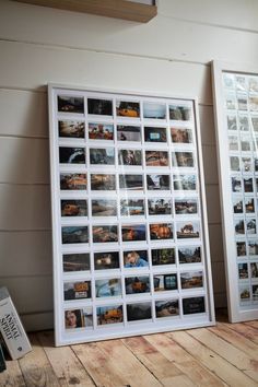 two framed photographs sitting on top of a wooden floor next to a wall with pictures