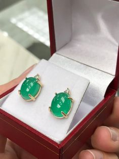 Featured here is a magnificent set of 8.50 total carat weight, cabochon-cut emerald & diamond studs in fine 14K yellow gold. Displayed are medium-green emeralds with very good transparency, accented by brilliant round diamonds in a simple four-prong gold mount, allowing for the emerald to be shown in full view. The earth mined, green emeralds have a desirable lush green color with excellent qualities. These earrings are ideal for everyday use and are the perfect accessory to any outfit. Emer Formal Fine Jewelry Gemstone Cabochons, Luxury Oval Cabochon Gemstone Earrings, Luxury Diamond Earrings With Cabochon, Luxury Diamond Cabochon Earrings, Fine Jewelry Cabochon Gemstones For Formal Occasions, Luxury Round Cabochon Earrings, Formal Fine Jewelry Cabochon Gemstones, Exquisite Formal Gemstone Cabochons, Green Gemstone Cabochons For Formal Use