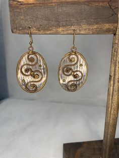 Handmade metal earrings. Approximately 1.75' long Bronze Teardrop Metal Jewelry, Metal Dangle Wrap Earrings, Bronze Metal Hoop Earrings, Wire Wrapped Metal Chandelier Earrings For Gift, Adjustable Gold Metal Pearl Earrings, Elegant Bronze Metal Plug Earrings, Nickel Free Bronze Jewelry, Gold Pearl Adjustable Earrings, Vintage Silver Brass Chandelier Earrings