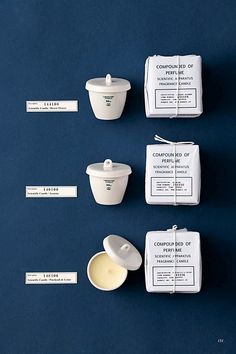 four different types of containers and labels on a blue surface with white tags attached to them