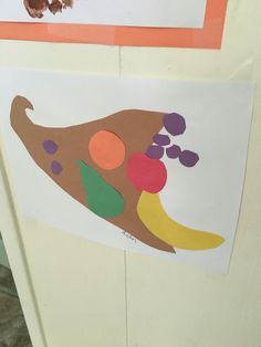 an art project is displayed on the door to children's artwork, including a piece of paper that has been cut out