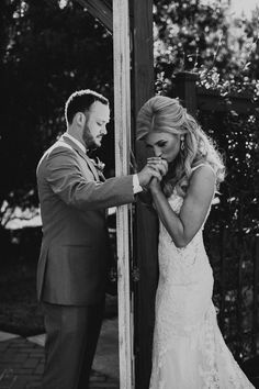 the bride and groom are getting ready for their wedding ceremony in black and white photo