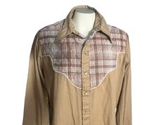 "Vintage 70's plaid cowboy shirt, tag says Sears, sz X-large, 65% polyester 35% cotton. Shirt is tan, quilted plaid detailing shoulders, snaps up with pearl buttons, shirt has stain on back- see last pic., measurements are shoulder to shoulder 18\" under arms 25\" across waist 24\" across length 29\" sleeve length 25\"" Western Style Brown Collared Top, Western Brown Collared Tops, Western Brown Tops With Snap Buttons, Fitted Plaid Western Tops, Fitted Western Plaid Tops, Fitted Western Brown Shirt, Fitted Brown Western Shirt, Brown Fitted Western Shirt, Brown Collared Western Shirt