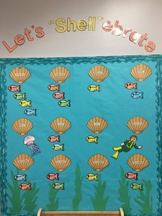 a bulletin board with shells and fish on it