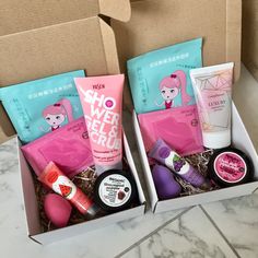 two boxes filled with different types of beauty products