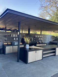 an outdoor covered area with tables and shelves