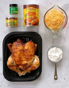 the ingredients to make a chicken dish laid out on top of a white marble counter