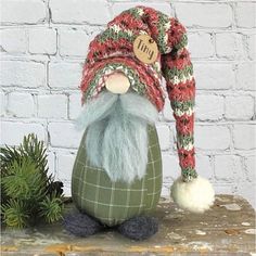 a green gnome with a red and white hat