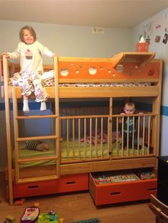 two children sitting on top of bunk beds