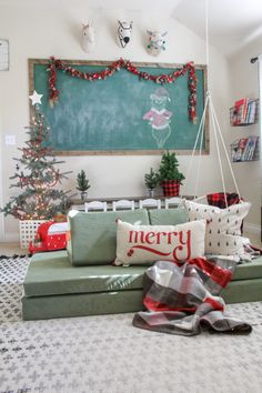 a living room decorated for christmas with a chalkboard on the wall