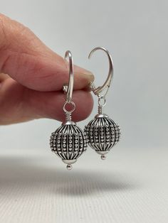 Sterling Silver Earrings Dangle. Leverback Earrings. These sterling silver Bali ball bead earrings are handmade. 12.3 mm wide, oxidized beads decorated with lines and granules are mounted with Euro-style leverback earring wires. The set is 1 1/2 inches (3.8 cm) in long. Pictures are enlarged to show detail. These are the lovely Bali sterling silver leverback earrings you will receive. Gift for Wife, Girlfriend Gift, Gift for Mom, Gift for Sister, Gift for Her, Gift for Women. The earrings ship in a small organza bag inside a gift box, ready to give... or keep! To see more WireAndPearl Sterling Silver Earrings, please visit: https://www.etsy.com/shop/WireAndPearl?section_id=18630564 Also, WireAndPearl Gold Filled and Vermail Earrings can be found here: https://www.etsy.com/shop/WireAndPearl Gift Sterling Silver Pierced Beaded Earrings, Pierced Sterling Silver Beaded Earrings As Gift, Unique Sterling Silver Beaded Earrings, Silver Beaded Drop Earrings As Gift, Silver Beaded Drop Earrings For Gift, Sterling Silver Beaded Earrings For Jewelry Making, Silver Teardrop Beaded Earrings As Gift, Sterling Silver Beaded Earrings As Gift, Silver Teardrop Beaded Earrings For Gift