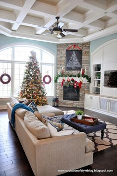 a living room filled with furniture and a christmas tree