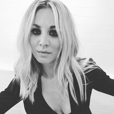 a black and white photo of a woman with long blonde hair in a bath room