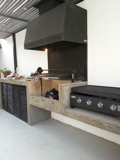 a stove top oven sitting inside of a kitchen next to a wall mounted range hood