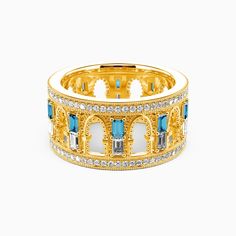 a yellow gold ring with blue and white stones on the inside, surrounded by diamonds