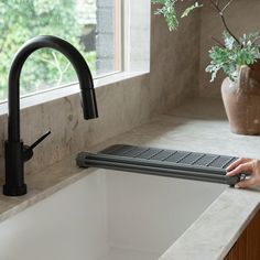 When you need all the counter space you can get — this is your duo. Our Over the Sink Dish Pad is a minimal, roll-out drying mat that’s easy to store away when not in use. With an instant drying Diomat(R) stone that anchors one end and silicone-covered stainless iron rods that roll out over your sink, it can hold even the heaviest pans – while protecting all of your dishes. The Stone Sink Caddy is a chic organizer for your soaps, lotions, and bottles brushes dries instantly. Its platform is made Stone Bathroom Accessories, Chic Organization, Sink Dish Rack, Modern Coasters, Sink Caddy, Stone Bathroom, Eco Friendly Kitchen, Over The Sink, Dish Rack