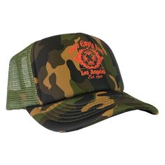 An adjustable unisex snap back trucker hat in green camo, and olive green netting with Smile Empty Soul "EST 1998" graphic printed on the front in red. One size fits most. Green Trucker Snapback Hat With Curved Bill, Military Camouflage Baseball Cap For Streetwear, Military Style Trucker Hat With Curved Brim, Camouflage Trucker Baseball Cap With Flat Bill, Adjustable Green Trucker Hat For Streetwear, Military Green Snapback Hats, Military Style Snapback Hat For Streetwear, Military Style Baseball Cap With Flat Bill For Streetwear, Green Military Baseball Cap With Flat Bill