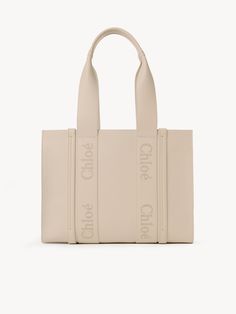 Chloé Medium Woody Tote Bag | Chloé US Beige Calf Leather Bag With Top Carry Handle, Daily Use Calf Leather Tote Bag, Beige Calf Leather Bag With Dust Bag, Beige Calf Leather Bag, Daily Use Calf Leather Tote Shoulder Bag, Calf Leather Tote Shoulder Bag With Handles, Calf Leather Tote Shoulder Bag For Daily Use, Calf Leather Tote Bag For Shopping, Beige Calf Leather Bag With Handle Drop