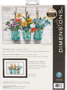 cross - stitch kit with flowers in vases on the front and back of it