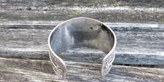 "This vintage, silver colored cuff bracelet is gorgeous! It has a really neat scrolling pattern on it. It's adjustable to your wrist size. Made in the 1960's Size: 1.5\" wide at largest point, adjustable fit Condition: good, light tarnish on inside Maker's Mark: None This model bracelet is retired and is no longer in production. All jewelry items come in a gift box" Vintage Stamped 925 Cuff Bracelet For Wedding, Adjustable Stamped Antique Silver Cuff Bracelet, Vintage Bangle Cuff Bracelet For Anniversary, Adjustable Vintage Sterling Silver Cuff Bracelet, Vintage Silver Adjustable Cuff Bracelet, Adjustable Silver Vintage Cuff Bracelet, Vintage Adjustable Silver Cuff Bracelet, Adjustable Vintage Bracelets Stamped 925, Vintage Stamped 925 Bangle Cuff Bracelet