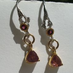 "I used the following materials for the earrings: Gemstone - Faceted tourmalines (top quality: almost clear and in a lovely pink. They come from Brazil, have only been polished and have a very, very good brilliance - they glitter much more beautifully than it may appear in the pictures) - faceted garnets (very good quality: only polished, faceted and in a beautiful red pink) Recordings were under sunlight metal - Gold wreath: \"gold filled\" - Remaining metal elements: 925 sterling silver - part Unique Pink Gemstone Earrings, Pink Ruby Earrings For Anniversary, Pink Tourmaline Jewelry With Prong Setting, Unique Pink Sterling Silver Earrings, Pink Sapphire Jewelry Set With Matching Earrings, Pink Tourmaline Dangle Jewelry, Pink Dangle Earrings With Prong Setting, Unique Pink Ruby Jewelry, Sterling Silver Pink Birthstone Earrings