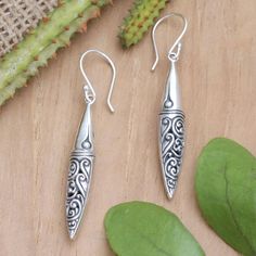 Bali's high-quality craftsmanship is present in this charming design made from sterling silver. Designed by Dewa Arimbawa, these dangle earrings feature traditional motifs in a combination finish, making an ideal accessory for casual or formal occasions. Traditional Sterling Silver Engraved Earrings, Traditional Engraved Sterling Silver Earrings, Ornate Engraved Sterling Silver Earrings, Traditional Engraved Teardrop Earrings, Traditional Long Drop Earrings For Pierced Ears, Feather Wings, Traditional Motifs, Gift Suggestions, Silver Feather