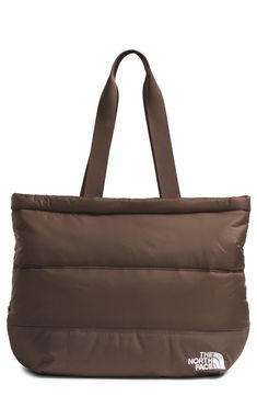 This comfortable, all-purpose tote for on-the-go days is made from durable ripstop complete with recycled synthetic insulation. It has interior organization with zip pockets to provide secure and easy-to-access storage. Top zip closure Top carry handles Exterior secure-zip pocket Laptop sleeve fits most 13" laptops; mesh pocket with key hook Lined, with recycled synthetic insulation 40-denier recycled nylon ripstop Hand wash, dry flat Imported Interior Organization, North Face Nuptse, Key Hook, Laptop Sleeve, Laptop Sleeves, North Face, The North Face, Insulation, Zip Pockets