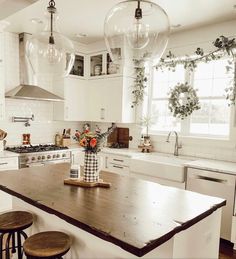 a kitchen with three stools and an island in front of the stove top oven