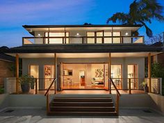 a modern house is lit up at night