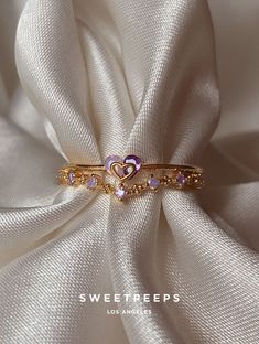 Product Details + Care - 18K Gold Dipped Over Brass - Brass: Copper + Zinc Alloy - 1 Ring - Wipe Clean - Imported Dimensions - Size is adjustable Have a question? Please message info@shopsweetpeeps.com and our support team will get back to you in 48 hours. Purple Heart Ring For Valentine's Day Wedding, Purple Heart Ring For Wedding On Valentine's Day, Cute Gold Rings For Valentine's Day, Gold Heart Ring For Valentine's Day, Cute Gold Heart Ring For Valentine's Day, Cute Gold Heart Ring As A Gift, Cute Gold Heart Ring As Gift, Cute Gold Heart Ring For Gift, Cute Gold Ring For Anniversary