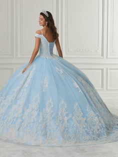 Receive lots of compliments in this long cold shoulder dress with A-line skirt by House of Wu Quinceanera Collection 26980. Made out of tulle, this beautiful off shoulder ball gown features a sweetheart bodice adorned with glitter floral appliques, cap sleeves, and gathering tulle with large glitter floral hem edge with layers of tulle A-line skirt. This look is finished with a lace-up corset back and a sweep train. House of Wu Quinceanera Collection Fall 2021 Style Number: 26980 Fabric: Tulle/G Applique Jumpsuit, Quinceanera Collection, Off Shoulder Ball Gown, Debutante Ball, Sheath Gown, Trumpet Dress, Terani Couture, Sequin Appliques, Quinceanera Dress