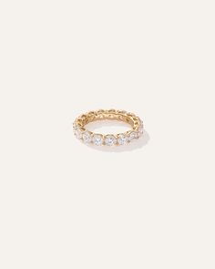 a gold ring with three diamonds on it