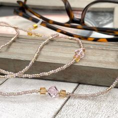 Sparkly eyeglass necklace chain made with Preciosa Czech crystal seed beads in golden tones with delicate multicolor flashes, featuring gold and pink cubic zirconia beads. Unique and bohemian this necklace chain will definitely create a unique look.   This eyeglass lanyard is made on strong quality beading wire with gold plated wire guardians that protect the quality eyeglass holder grips. The necklace is ended with spring clasps that hold the eyeglass grips and they can be easily removed to tra Adjustable Crystal Necklaces With Colorful Glass Beads, Glass Beaded Necklaces With Adjustable Chain, Bohemian Gold Glasses Chains With Colorful Beads, Adjustable Chain Glass Beaded Necklaces For Jewelry Making, Adjustable Glass Beaded Necklaces With Tiny Beads, Adjustable Glass Beaded Necklace With Tiny Beads, Adjustable Tiny Beaded Glass Necklaces, Gold Beaded Glass Crystal Necklaces, Adjustable Tiny Beaded Glass Necklace