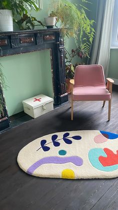 a living room with a chair and rug on the floor